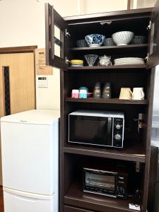 A kitchen or kitchenette at ポートサイドSasebo藤原町