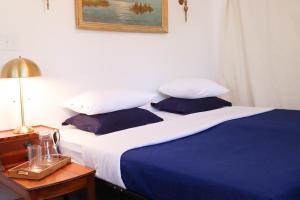 a bedroom with a blue and white bed with a night stand at 1 BR Orchard Cottage - Gateway to Two National Parks! in Visalia