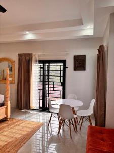 a living room with a white table and chairs at Beachscape At Black River Ethlyn by the sea in Black River