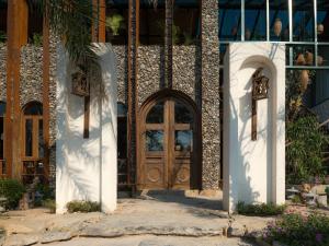 a building with a wooden door on the side of it at Ailee Villa&Hotel TamCoc in Ninh Binh
