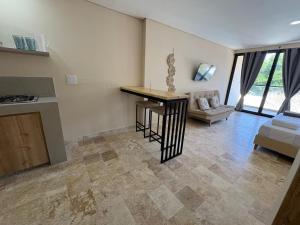 a kitchen and living room with a table and a couch at Forest Condominio in Coveñas