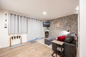 a living room with a couch and a tv at Stunning Deluxe King Studio #124 at Donner Lake Village in Truckee