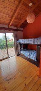 a bedroom with two bunk beds and a wooden floor at La Reserva in Los Altos
