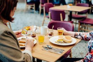 two women sitting at a table eating breakfast at Mary MacKillop Place in Sydney