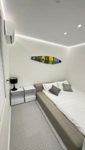 a bedroom with a bed with a surfboard on the wall at 16 Post Station Single Tour in Hengchun