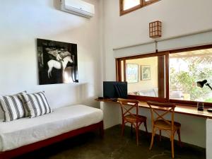 a bedroom with a bed and a desk with a computer at Casa Pacifico in Los Órganos