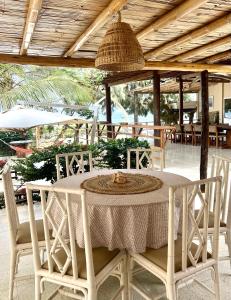 a white table with chairs and a bowl on top at Casa Pacifico in Los Órganos
