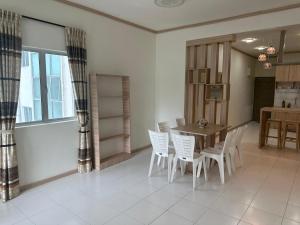 a dining room with a table and white chairs at Family Stay at Quintet A3A-3A-6 in Tanah Rata