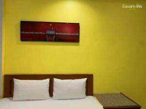 Postel nebo postele na pokoji v ubytování โรงแรมอีสานอินน์ ยโสธร - Easarninn Yasothorn