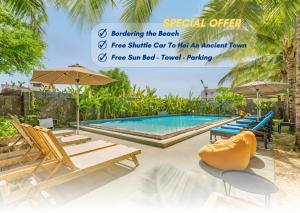 a resort with a swimming pool with chairs and umbrellas at Athenia Hoi An Boutique Hotel & Spa in Hoi An