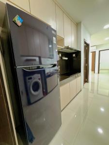 a kitchen with a refrigerator with a camera on it at BCC Hotel & Residence Apartment in Bagam