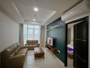 a living room with a couch and a table at BCC Hotel & Residence Apartment in Bagam