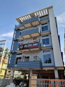 a tall blue building with a sign on it at Alohi Homestay Near Rahman Hospitals Pvt Ltd in Guwahati