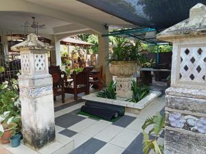 un patio al aire libre con un jarrón grande y una mesa en Villa Medina 12 pax private bungalow at Pantai Bagan Lalang, en Tanjong Sepat 12 fotos más