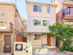an apartment building with a parking meter in front of it at 上野Nipporiテラスー寛道ー in Tokyo