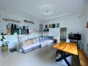 a living room with a couch and a table at Bughaw Dive House - Anilao, Mabini, Batangas in Mabini +9 photos