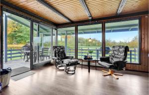 two chairs and a table in a room with windows at Holiday Home Egernsund With A Fireplace 320 in Egernsund