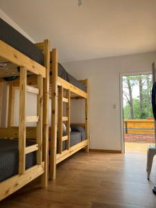 a room with two bunk beds and a patio at Diez Pinos in Punta del Este