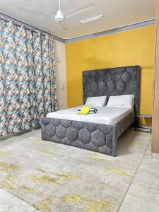 a bedroom with a large bed in a room at Soft Greys Homes in Mombasa