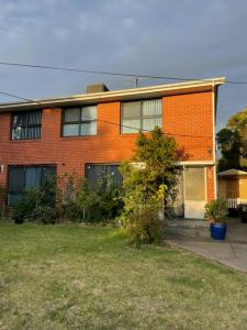 a red brick house with a door and a yard at Home in Laverton 19 Minutes to Melbourne CBD in Laverton