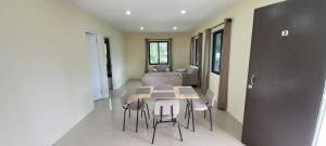 a dining room with a table and chairs and a bed at Sac Accommodations in Langgere