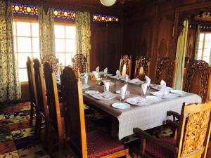 a dining room table with plates of food on it at Houseboat Sweet Star in Srinagar