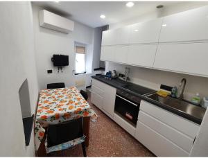 a small kitchen with a table and a sink at Casa nel borgo in Albisola Superiore