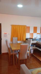 a dining room with a wooden table and chairs at Apartamento #5 in Puerto Colombia
