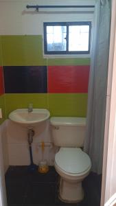 a bathroom with a toilet and a sink at Apartamento #5 in Puerto Colombia
