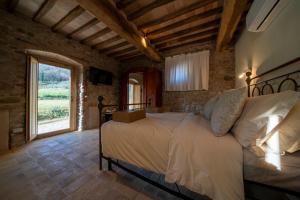Posteľ alebo postele v izbe v ubytovaní Agriturismo Podere Tovari