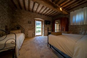 Posteľ alebo postele v izbe v ubytovaní Agriturismo Podere Tovari