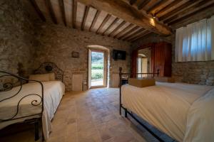 Posteľ alebo postele v izbe v ubytovaní Agriturismo Podere Tovari