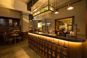 a bar in a restaurant with a mirror at The Station Hotel in Rothes