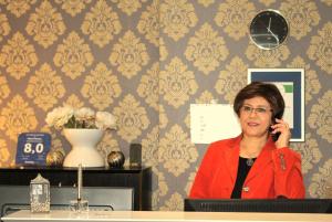 a woman talking on a cell phone in a room at Hotel Famosa in Düsseldorf