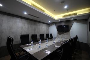 a conference room with a long table and chairs at Hotel Rockdale in Visakhapatnam