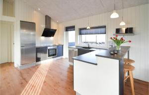 a kitchen with a stainless steel refrigerator and a counter at Three-Bedroom Holiday Home In Hvide Sande in Bjerregård