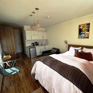 a bedroom with a large bed and a kitchen at New Gudauri Redco Loft 1 in Gudauri