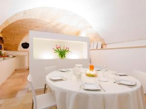 a white table with white chairs and a white table cloth at Nonna Jole in Lecce