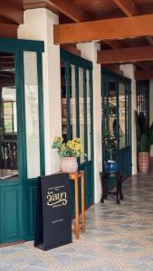 een restaurant met een bord voor een gebouw bij Wallaya Heritage Stay in Bangkok