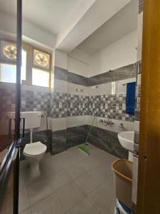 a bathroom with a toilet and a sink and a tub at Yul-Gal Homestay By StayApart in Kaza +35 photos