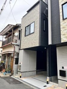 a house with a garage on a street at Casa Stella 4 by Liaison in Osaka