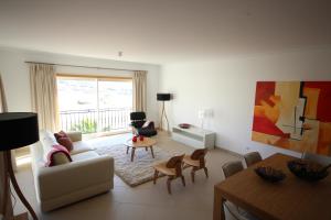 a living room with a couch and chairs and a table at Josefa D’Óbidos Apartment in Casal da Lagoa Seca
