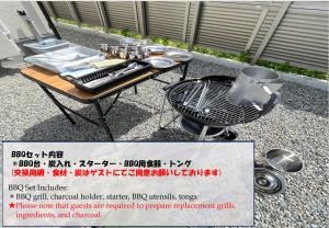 a picnic table with a grill and equipment on it at Villa ANOTONA No 1 in Fujikawaguchiko
