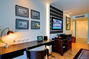 a home office with a desk and a tv on a wall at Wave Hotel Pattaya in Pattaya Central