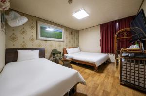 Postel nebo postele na pokoji v ubytování Jeju Top Motel