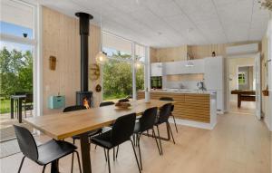 a kitchen and dining room with a wooden table and chairs at Lovely Home In Knebel With Kitchen in Knebel
