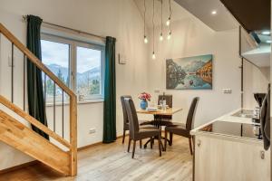 a kitchen and dining room with a table and chairs at Uii Apartments Oberaudorf in Oberaudorf