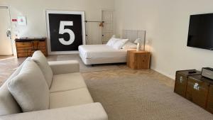 a living room with a couch and a television at Downtown collection apartments in Funchal