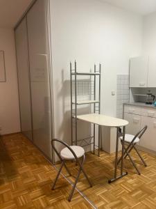 a table and two chairs in a kitchen at Study & Work am Campus Chemnitz in Chemnitz