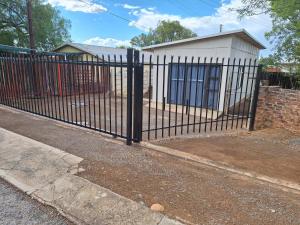 a black metal fence in front of a house at Alhoa 4 in Gariep Dam
